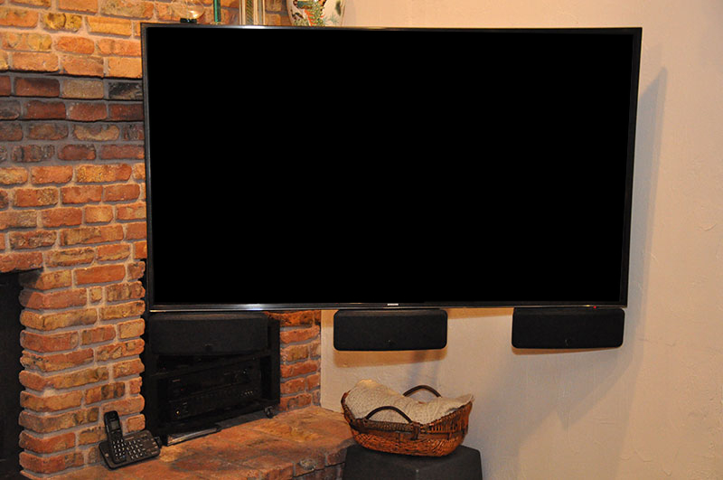 Den TV, mounted on the wall on a heavy-duty swing-arm